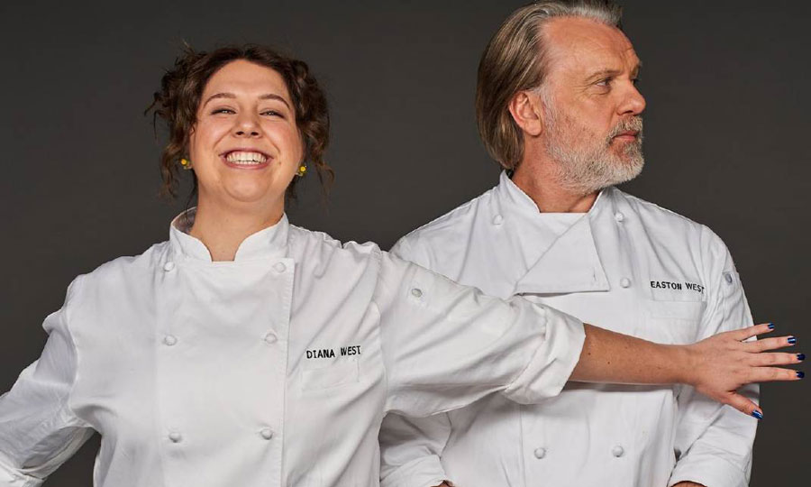 A young white woman chef and an older white male chef